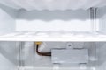 Freezer compartment with frozen ice and evaporator, selective focus. Defrost fridge and freezer Royalty Free Stock Photo