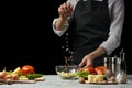 Freezer food prepare in process vegetarian salad by chef hand in home kitchen. Dark black background with Text area for design men