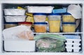 A packed freezer with soup and chicken