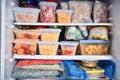 freezer with variety of frozen foods and snacks, including individually wrapped ice pops