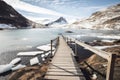 freezing fiord with boardwalk and wooden steps leading down to glacial lagoon