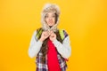 Freezing here. Eskimo funny schoolgirl try on hat enjoy softness. Winter season concept. Northern region fashion. Soft