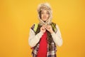 Freezing here. Eskimo funny schoolgirl try on hat enjoy softness. Winter season concept. Northern region fashion. Soft