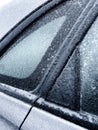 Freezing rain. Close-up details of a frozen parked car in the morning of a winter day.