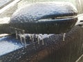 freezing rain ice on car side mirror in winter Royalty Free Stock Photo
