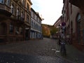 Empty side street on Sunday morning in Freiburg\'s historic center with bicycles tied to road sign.