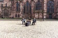 Two accordions and cymbals - three musicians on the square near Freiburg Cathedral