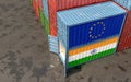 Freight containers with India and European Union flags.