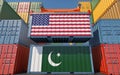 Freight containers with USA and Pakistan national flags. Royalty Free Stock Photo