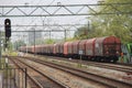 Freight locomotive with cargo wagons along platform of train station Den Haag Laan van NOI