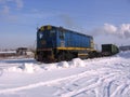 Freight locomotive train on the rails of the industrial railway in the winter