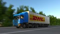 Freight semi truck with DHL Express logo driving along forest road. Editorial 3D rendering Royalty Free Stock Photo