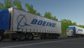Freight semi trucks with Boeing Company logo driving along forest road. Editorial 3D rendering