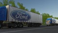 Freight semi trucks with Ford Motor Company logo driving along forest road. Editorial 3D rendering