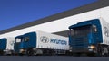Freight semi trucks with Hyundai Motor Company logo loading or unloading at warehouse dock. Editorial 3D rendering