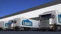 Freight semi trucks with Lowe`s logo loading or unloading at warehouse dock. Editorial 3D rendering