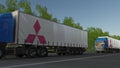 Freight semi trucks with Mitsubishi logo driving along forest road. Editorial 3D rendering