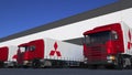 Freight semi trucks with Mitsubishi logo loading or unloading at warehouse dock. Editorial 3D rendering