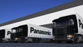 Freight semi trucks with Panasonic Corporation logo loading or unloading at warehouse dock. Editorial 3D rendering
