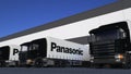Freight semi trucks with Panasonic Corporation logo loading or unloading at warehouse dock, seamless loop. Editorial