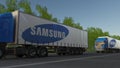 Freight semi trucks with Samsung logo driving along forest road. Editorial 3D rendering