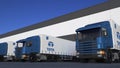 Freight semi trucks with Tata Group logo loading or unloading at warehouse dock. Editorial 3D rendering