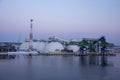 Freight shipping containers and gas tanks at the docks. in import export and business logistic. Trade Port, Ship cargo to harbor. Royalty Free Stock Photo