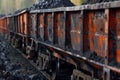 A freight train car laden with coal is on the railway tracks Royalty Free Stock Photo