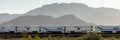 Freight train carries truck trailers under mountain near Needles