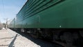 A freight train carrying coal. Clip. A cargo train coming and passing fast on blue sky background, concept of Royalty Free Stock Photo