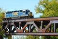 Freight Train Crossing a Steel Railroad Truss River Bridge Royalty Free Stock Photo