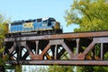 Freight Train Crossing a Steel Railroad Truss River Bridge