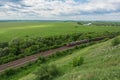 Freight train with locomotives passing by rail in Russia, along the typical Russian landscape, top view