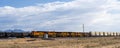 Freight train moving through desert landscape of Mojave Desert Royalty Free Stock Photo