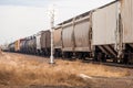 A freight train passing a railrod signal.