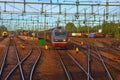 Freight train passing railway station Royalty Free Stock Photo