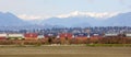 Freight Train passing Scenic Mountain backdrop to Vancouver, BC Royalty Free Stock Photo