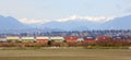 Freight Train passing Scenic Mountain backdrop to Vancouver, BC Royalty Free Stock Photo