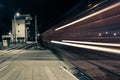 A freight train passing through the train station at night