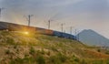 Freight train passing by on sunset Royalty Free Stock Photo