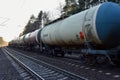 Freight train with petroleum tank cars on railroad. Rail cars carry oil and ethanol. Railway logistics transportation of methanol