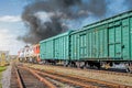 Freight train railroad departure from starion with black smoke. Royalty Free Stock Photo