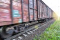 Freight train, railway wagons with motion blur effect. Transportation, railroad. Royalty Free Stock Photo