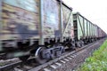 Freight train, railway wagons with motion blur effect. Transportation, railroad. Royalty Free Stock Photo