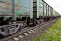 Freight train, railway wagons with motion blur effect. Transportation, railroad. Royalty Free Stock Photo