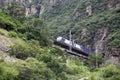 A freight train runs on a railway bridge in a valley Royalty Free Stock Photo