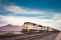 Freight train traveling Arizona desert. Royalty Free Stock Photo