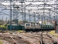 Freight train with two locomotives at the head and coupled wagons parked on the service tracks Royalty Free Stock Photo