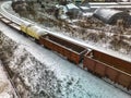 Freight train in winter. Freight train in the snow. Freight wagons of the train at the railway turn. Drone photography. Close-up Royalty Free Stock Photo