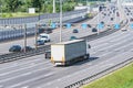 Freight truck and passenger cars move.